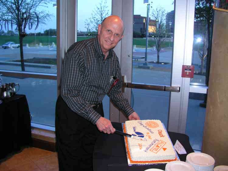 Chuck Flint prepares to cut his retirement cake