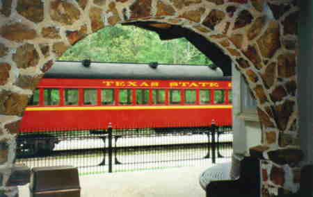 A car on the Texas State Railroad framed by the Palestine Station Arch