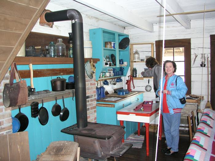 Natalee checks out the kitchen inside the one roomed cabin