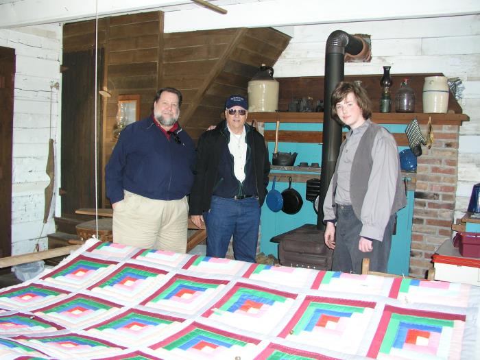 Admiring the quilt, stair case in rear