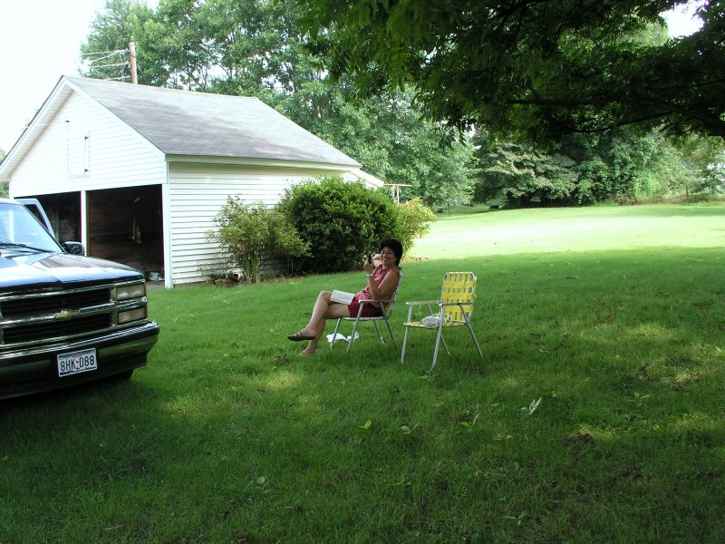 Angie relaxes under the shade of the pecan tree.