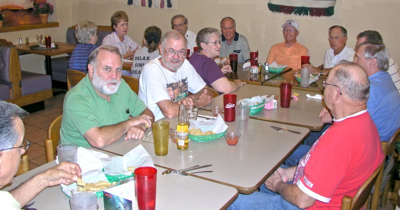 Clockwise around the tables from lower left: Bob Everett, Gerry Brown, Marvin Howard,Francis Bradford, Carol George, Dorothy McGrath, Wanda Fox, Dennis Kaplan, Mike Crye, Eldon Streck, Doug Dreggors, Jack Bowling, George Huling, and Doug Sloan