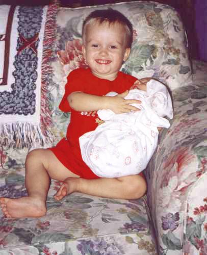 Christopher Larson holding his new sister Amanda